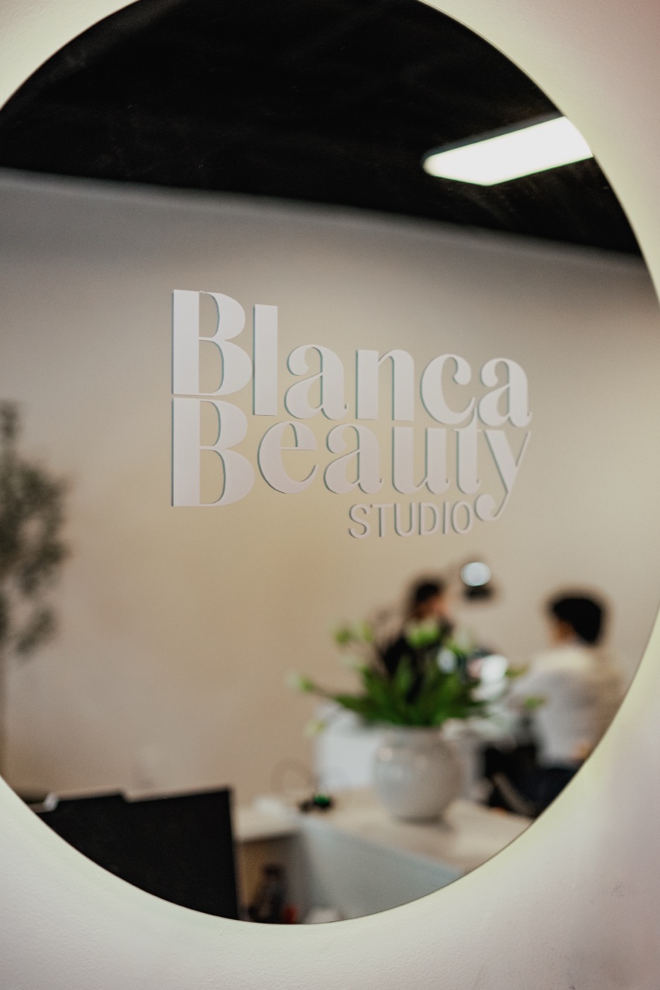 A client sips espresso while a Blanca specialist works at the manicure station