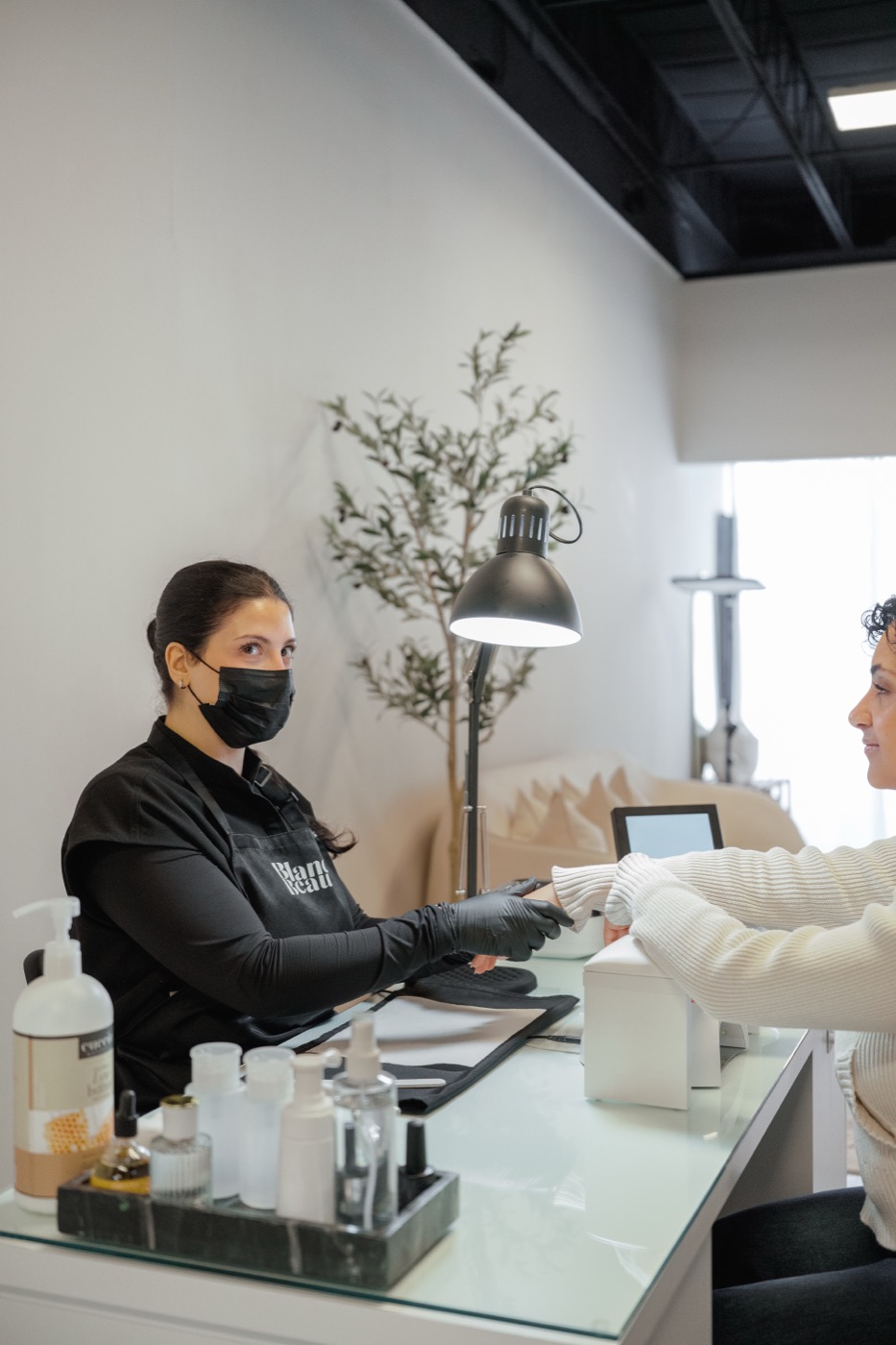 Manicurist with client at the station